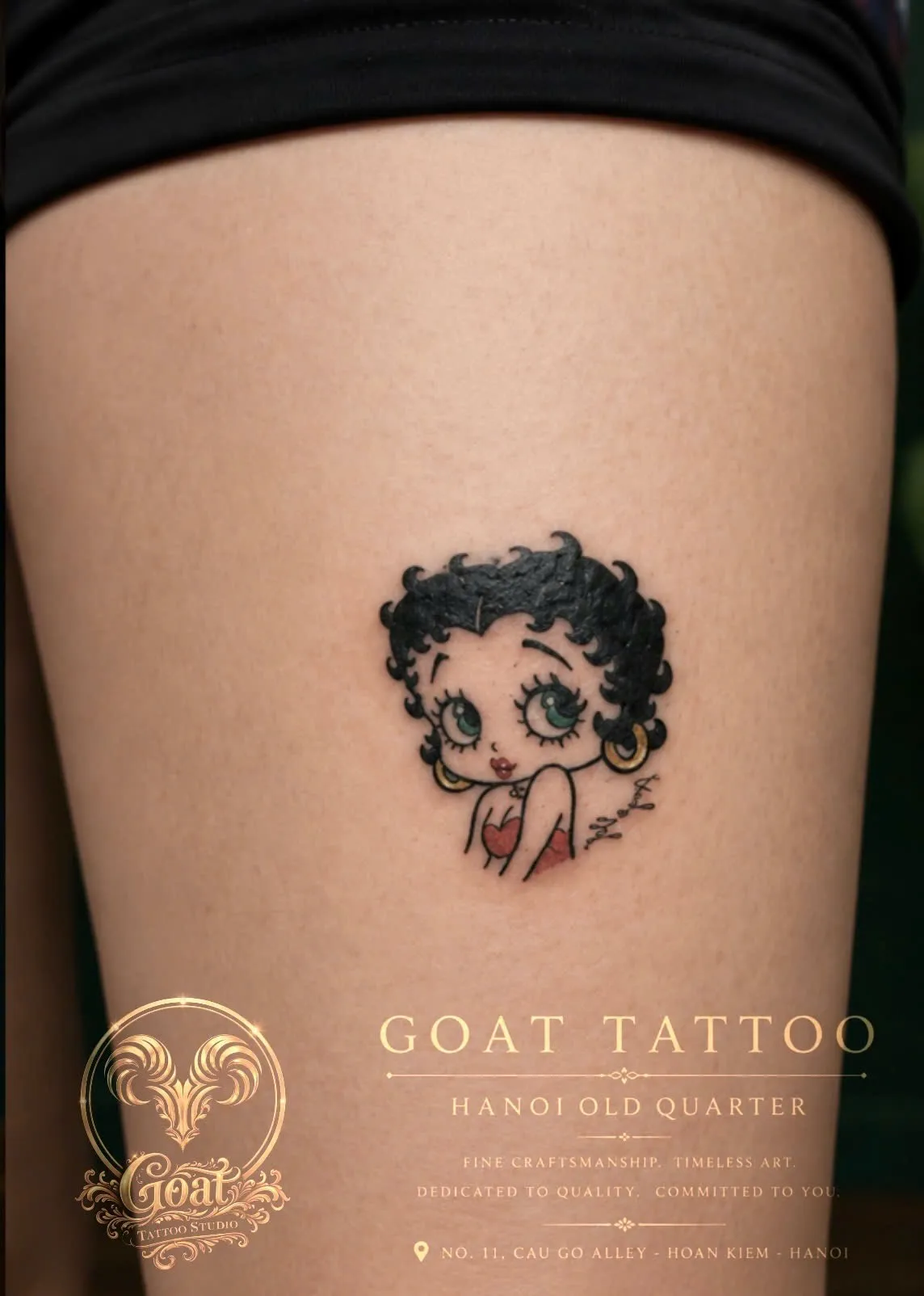 A playful color tattoo of the classic cartoon icon Betty Boop on the thigh, done at GOAT Tattoo Studio in Hanoi's Old Quarter.