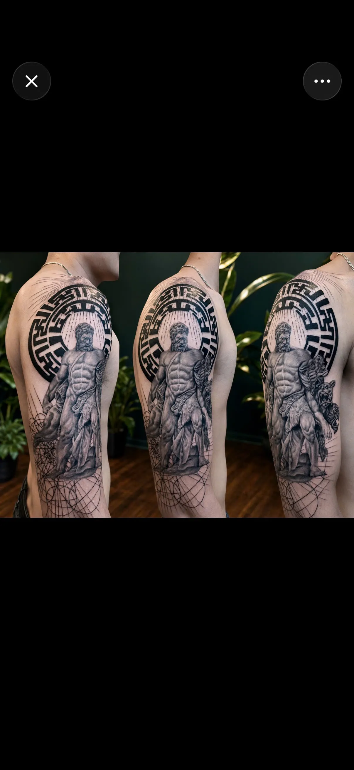Blackwork geometric tribal tattoo pattern across the shoulder and chest, by GOAT Tattoo Studio in Hanoi.
