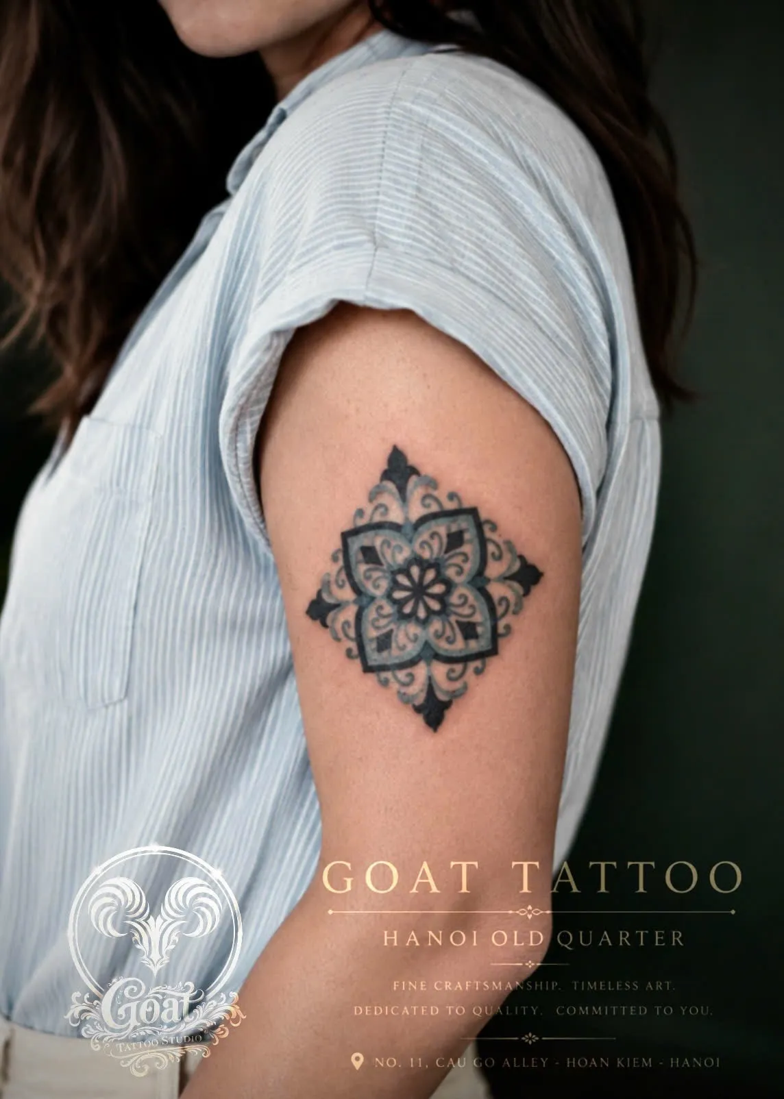 Blackwork geometric mandala flower tattoo on the upper arm, by GOAT Tattoo Studio in Hanoi.