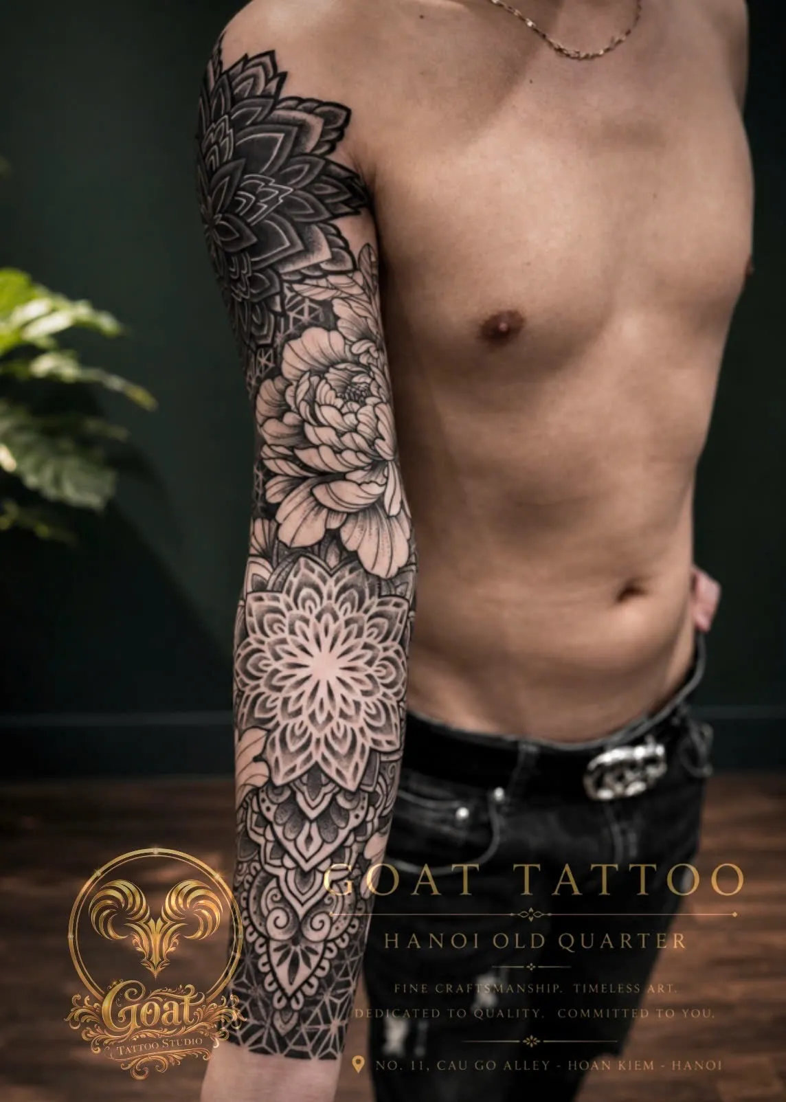 Blackwork dotwork mandala and floral sleeve tattoo covering the arm, by GOAT Tattoo Studio in Hanoi.