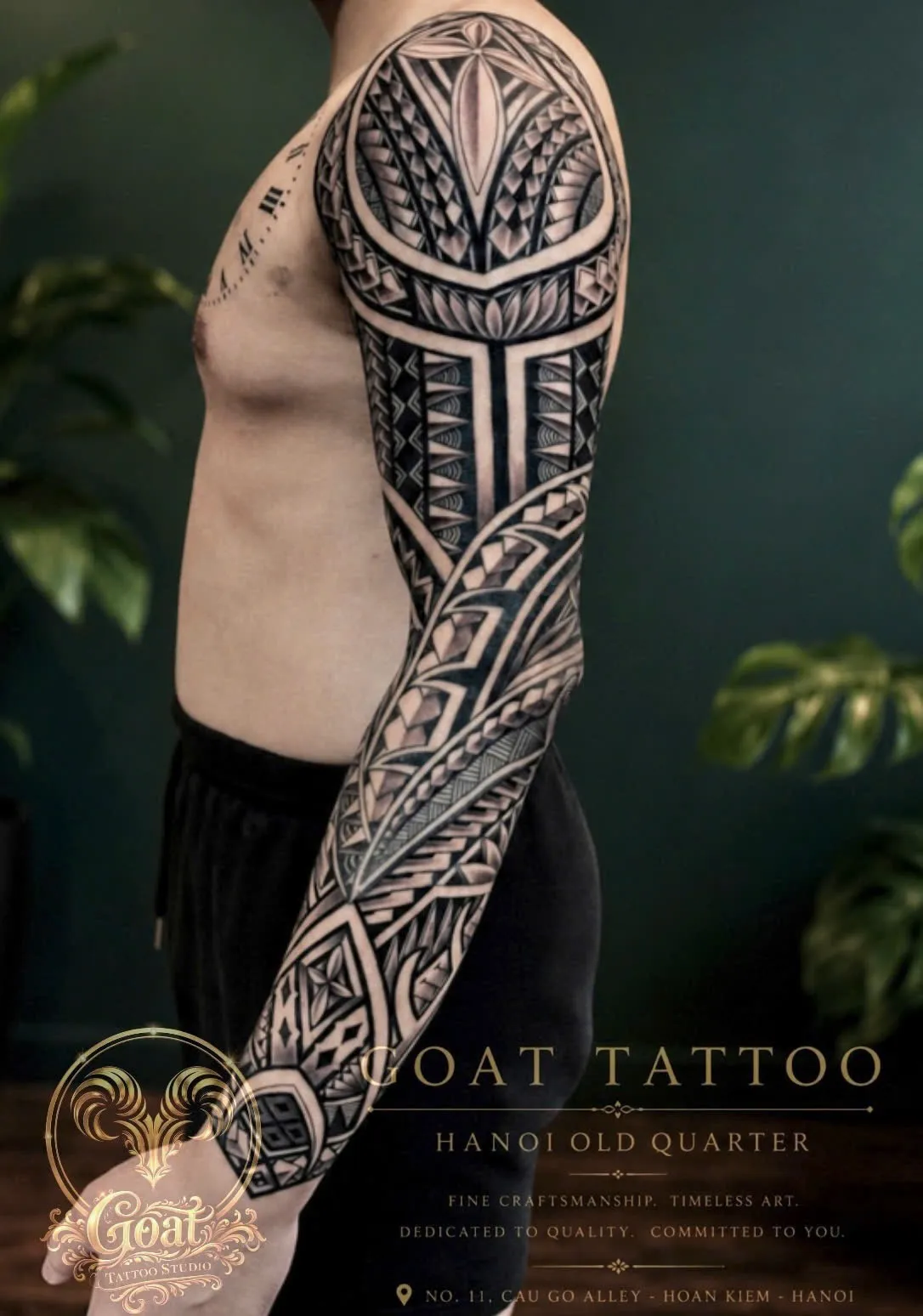 Blackwork Polynesian tribal pattern tattoo covering the full arm sleeve, by GOAT Tattoo Studio in Hanoi.