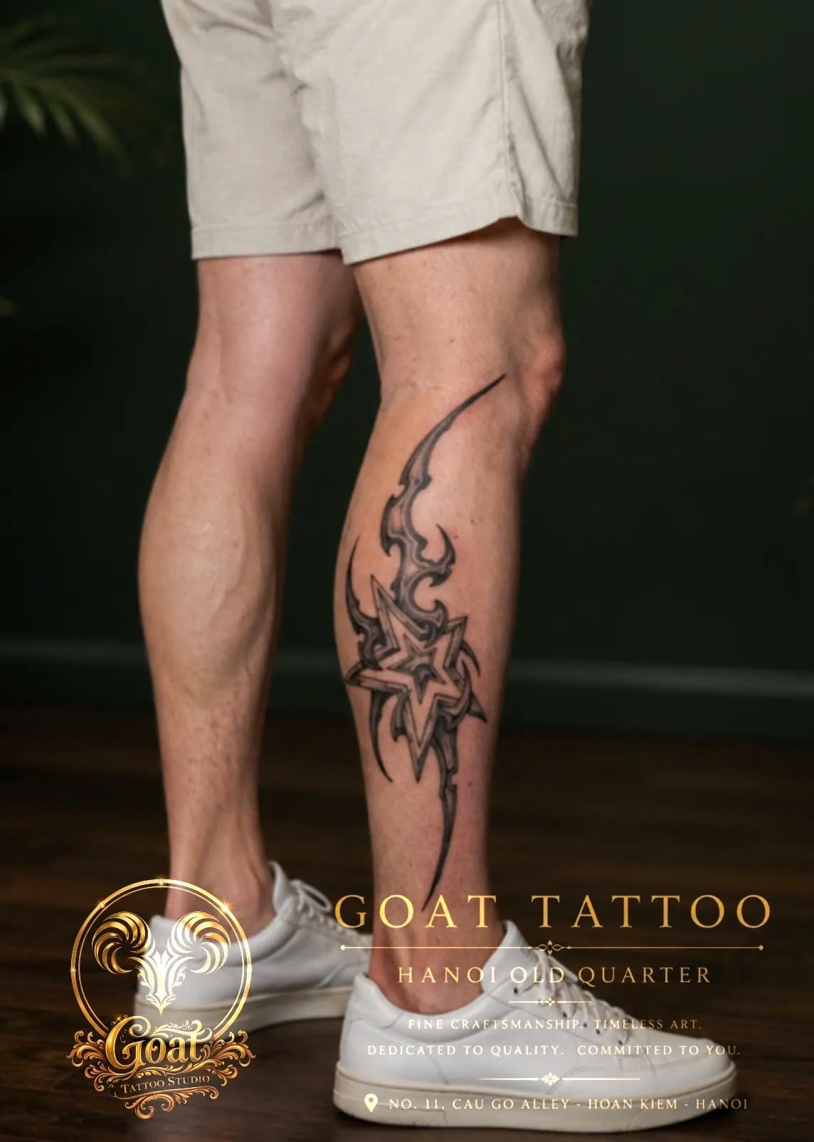 Blackwork tribal-style star and flame design running along the calf and shin, by GOAT Tattoo Studio in Hanoi.