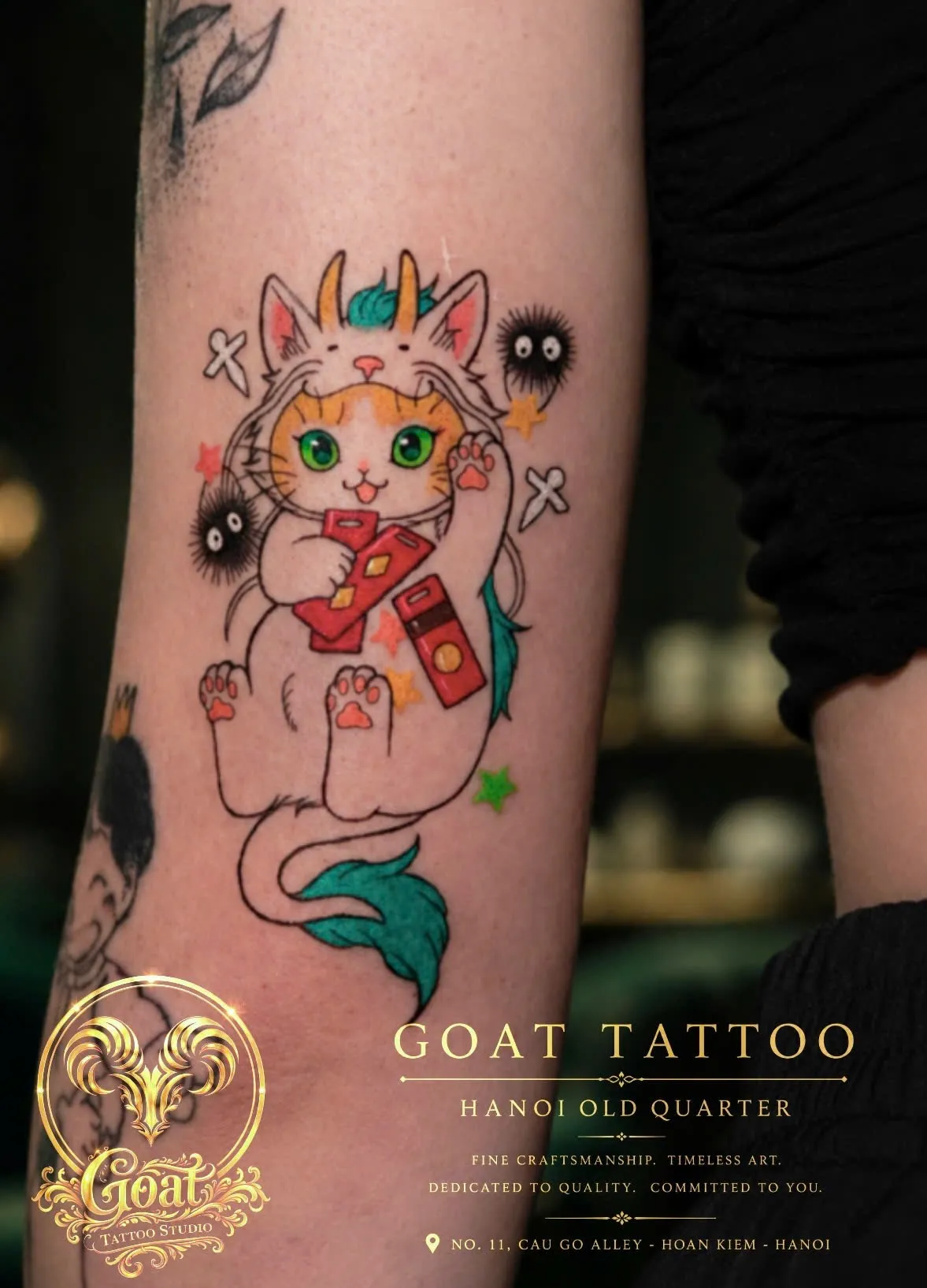 Color Japanese-anime style cat character tattoo holding fireworks on the forearm, by GOAT Tattoo Studio, Hanoi.