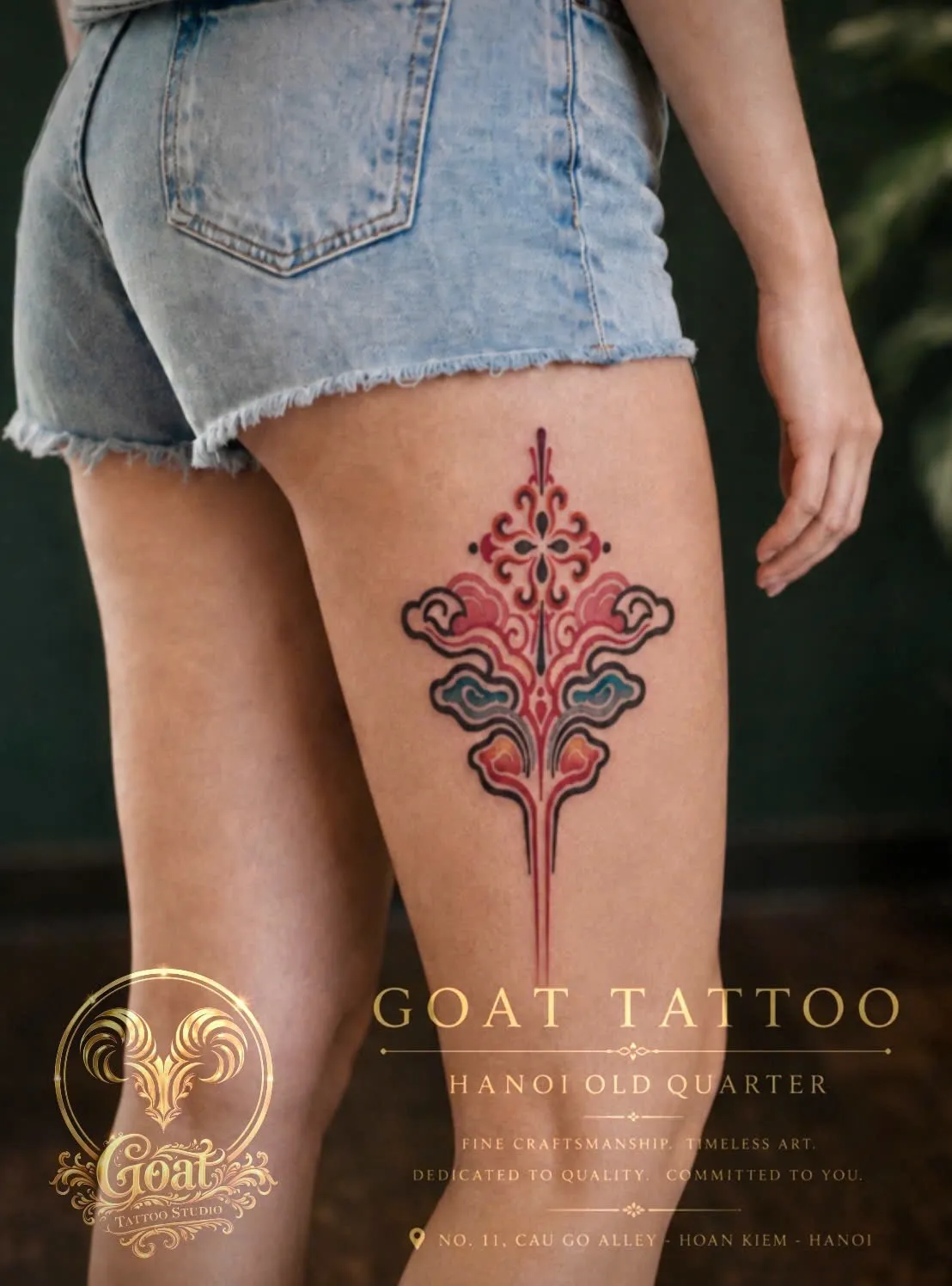 Color Asian-inspired ornamental cloud and flame motif tattoo on the back of the thigh, by GOAT Tattoo Studio Hanoi.
