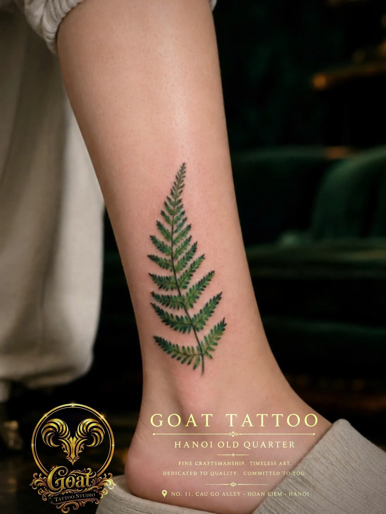 Realistic color fern leaf tattoo detailed on the ankle, by GOAT Tattoo Studio in Hanoi's Old Quarter.