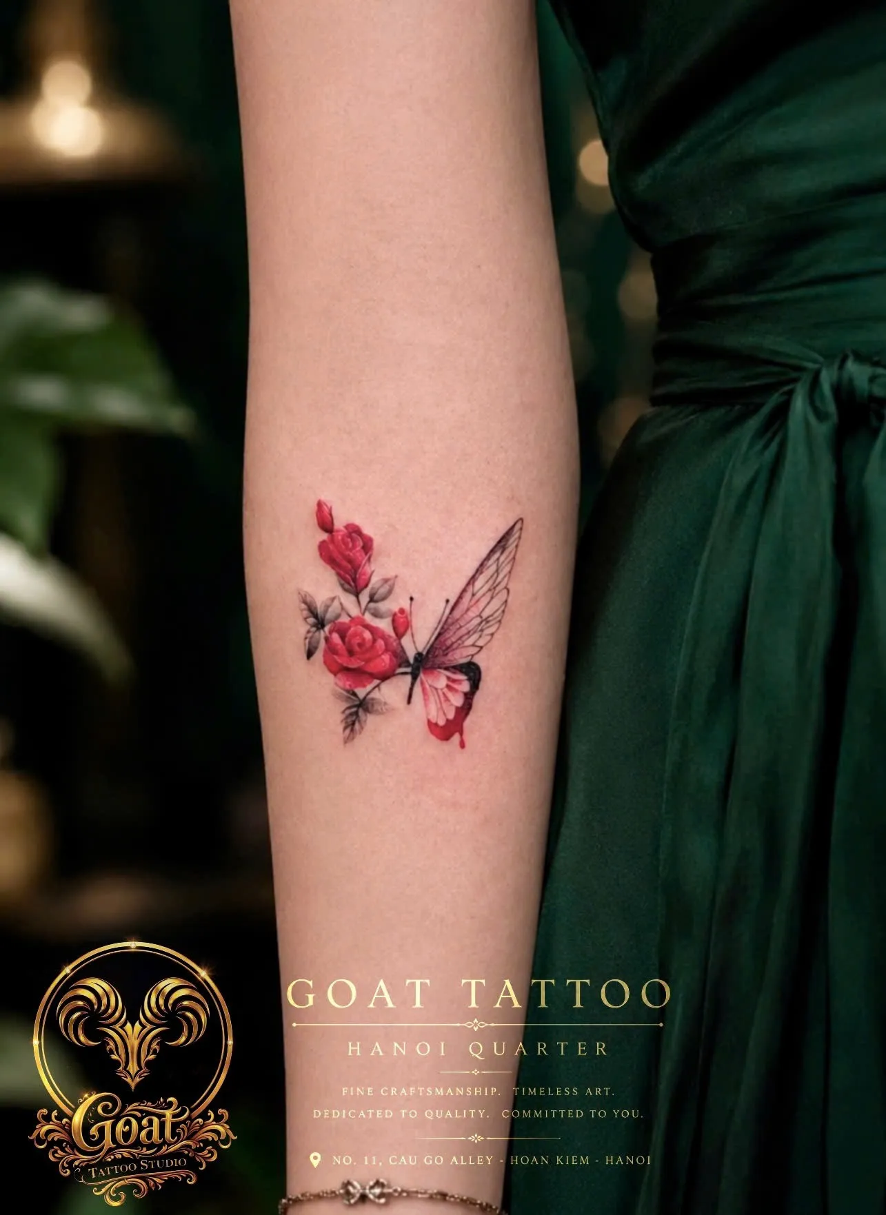 Color illustrative red rose and butterfly tattoo detailed on the forearm, by GOAT Tattoo Studio in Hanoi's Old Quarter.