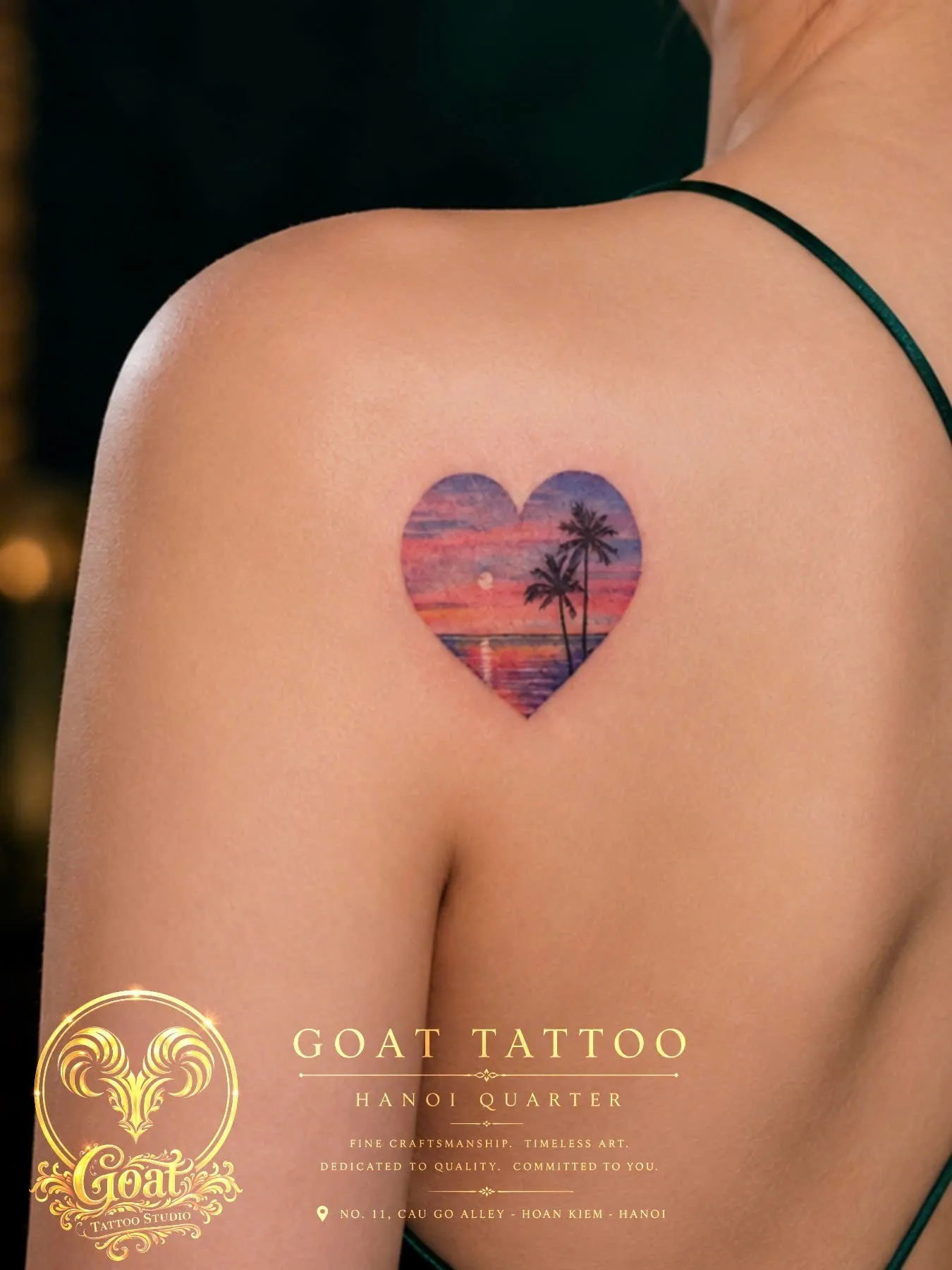 Color watercolor sunset beach scene shaped like a heart on the shoulder blade, by GOAT Tattoo Studio in Hanoi.