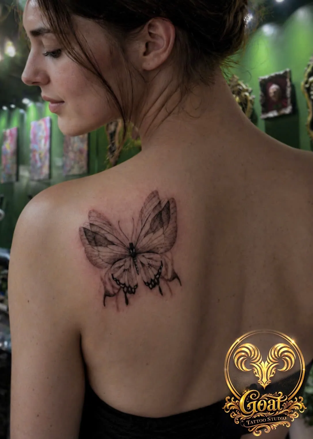 Delicately shaded black and grey butterfly tattoo on the shoulder blade, by GOAT Tattoo Studio in Hanoi.