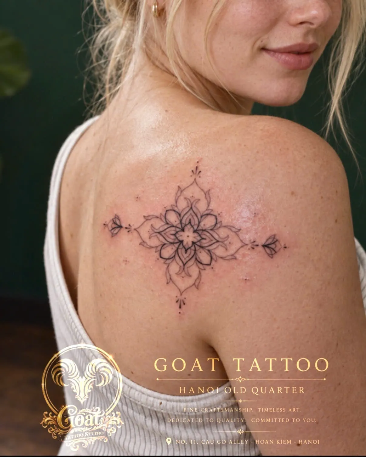 A fine line lotus-inspired mandala tattoo on the shoulder blade, by GOAT Tattoo Studio in Hanoi's Old Quarter.