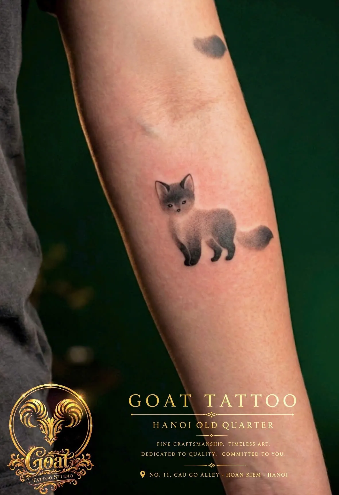 Soft grey-wash minimalist fox tattoo placed on the forearm, by GOAT Tattoo Studio in Hanoi.