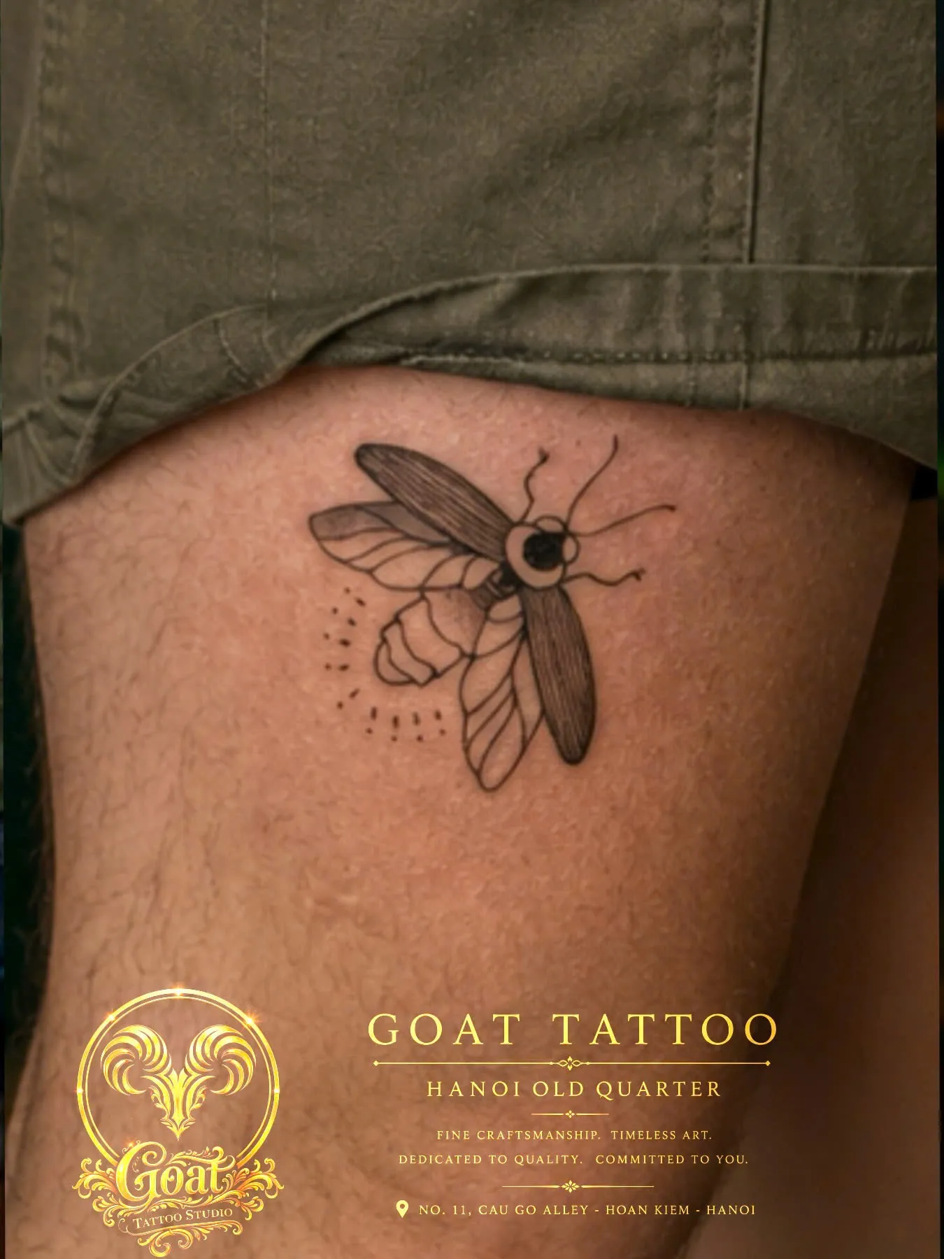 Detailed fine line moth tattoo with dotwork accents inked on the thigh, GOAT Tattoo Studio Hanoi.