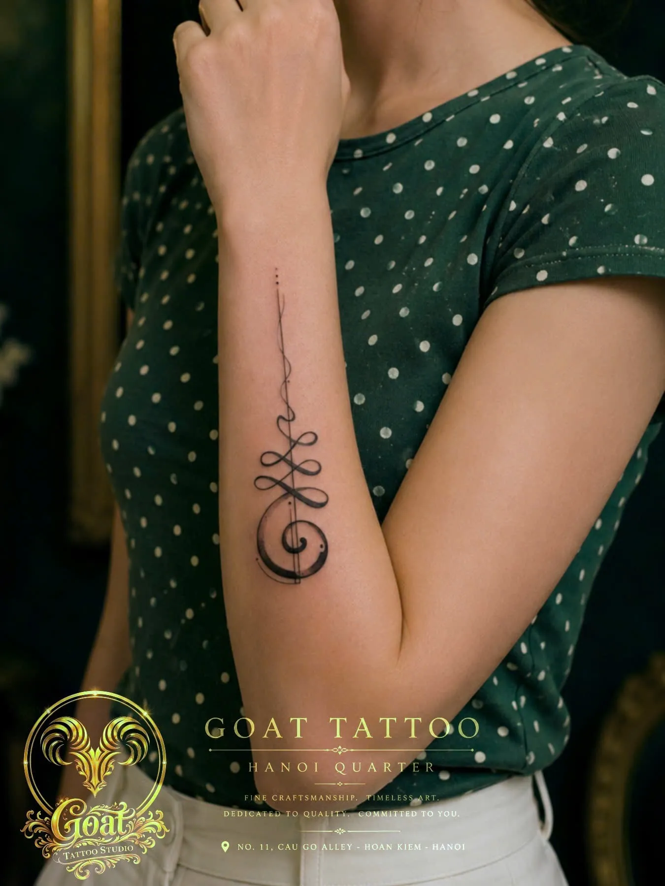 Fine line abstract unalome symbol tattoo running along the inner forearm, by GOAT Tattoo Studio in Hanoi.