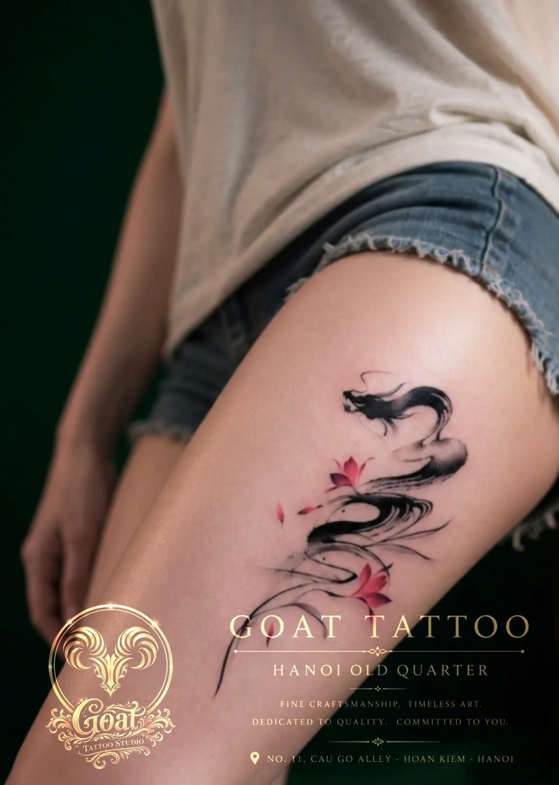 Ink-wash style dragon tattoo accented with pink lotus flowers on the hip and thigh, by GOAT Tattoo Studio in Hanoi.