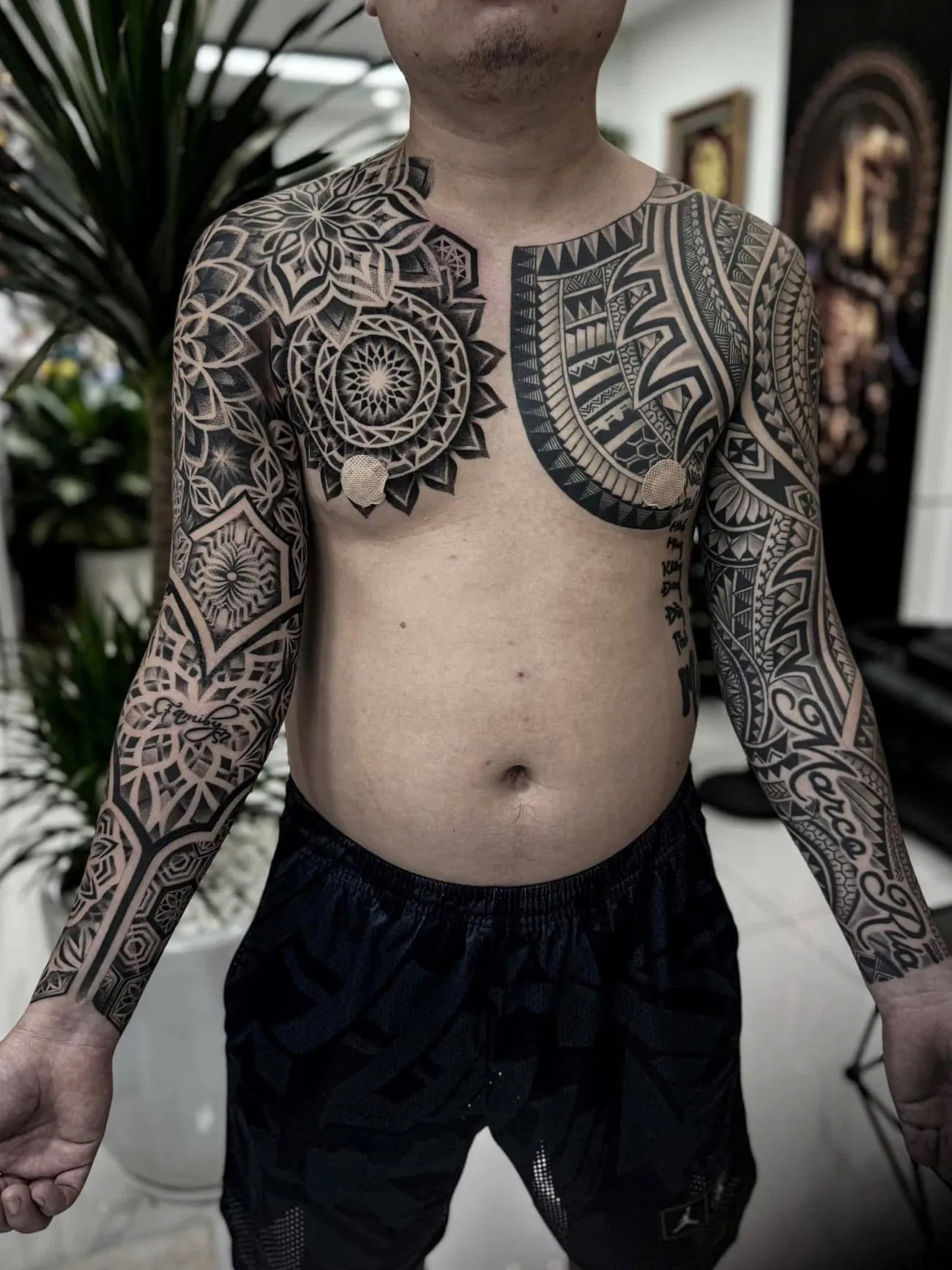 Maori and Polynesian tribal chest panel joined to two full sleeves, done at GOAT Tattoo Studio in Hanoi.