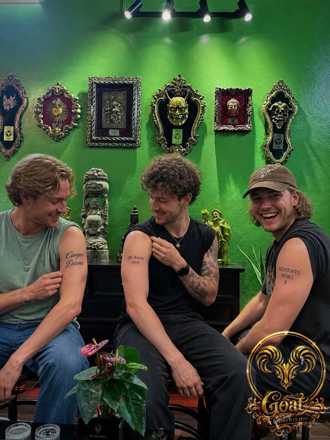 Three friends showing matching lettering tattoos reading Carpe Diem, Be Here Now, and Memento Mori, by GOAT Tattoo Studio, Hanoi.