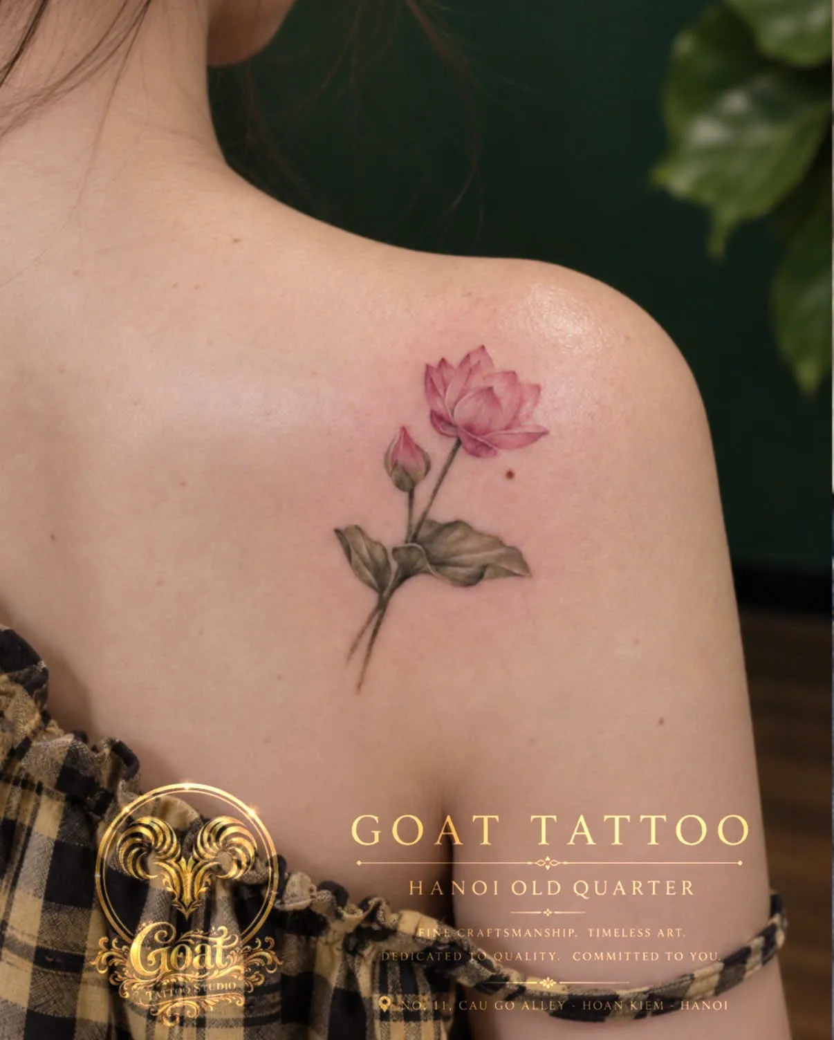 A soft watercolor-style pink lotus flower tattoo on the shoulder blade, by GOAT Tattoo Studio Hanoi.