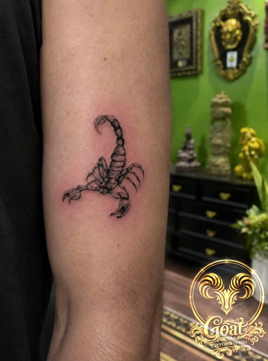 Black and grey realistic scorpion tattoo on the inner forearm, by GOAT Tattoo Studio in Hanoi's Old Quarter.