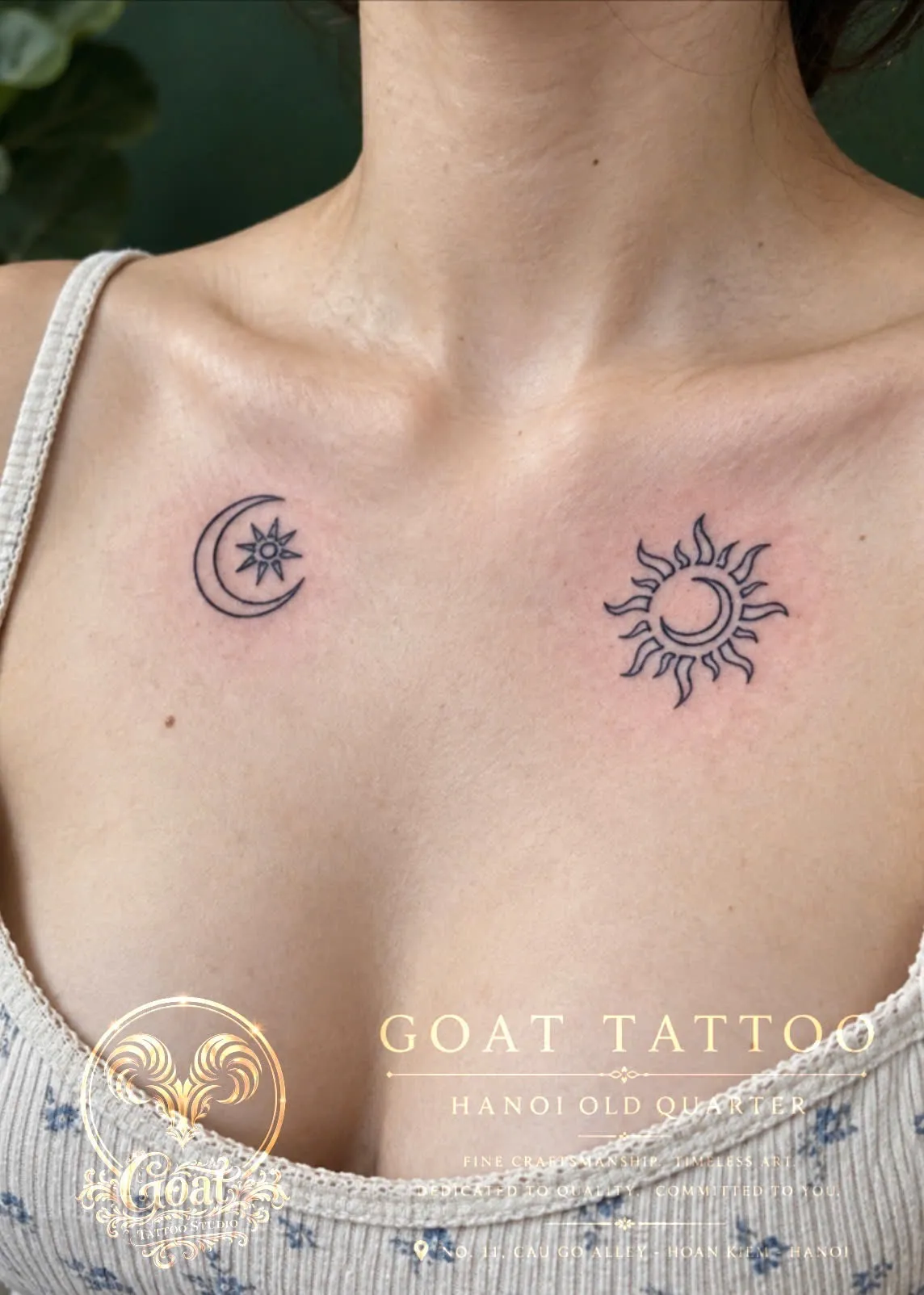 A matching sun and crescent moon fine line tattoo across the collarbones, by GOAT Tattoo Studio in Hanoi's Old Quarter.