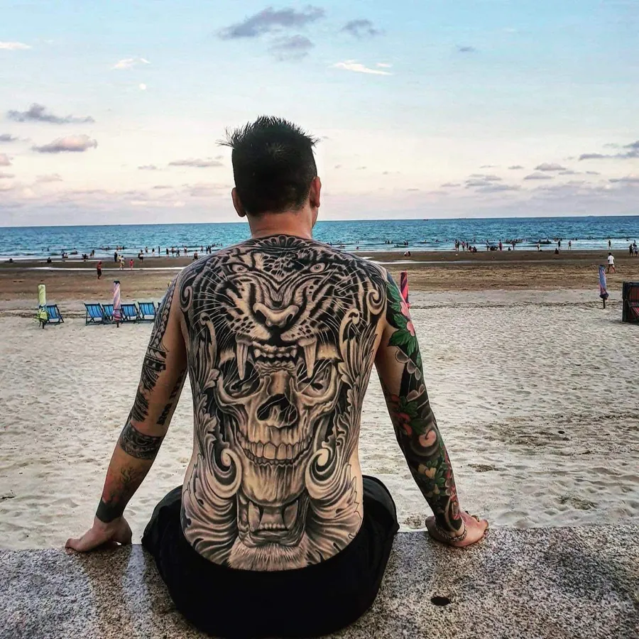 Black and grey tiger and skull full back tattoo, photo shared by the reviewer