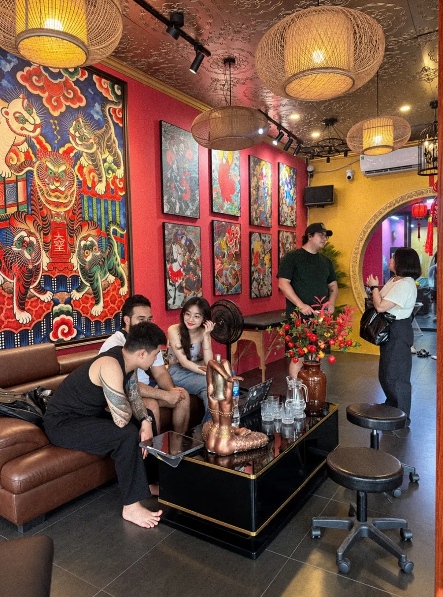 Guests relaxing in the lounge of GOAT Tattoo Studio at 56 Trang Thi Street, Hanoi